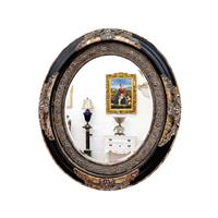 Miroir ovale baroque en bois noir et argenté Agassac